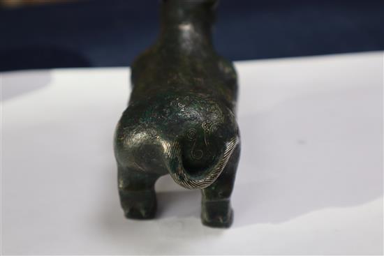 A Chinese gold and silver inlaid bronze figure of a tapir, Han dynasty or later, L. 12cm, excluding hardwood stand and fitted box